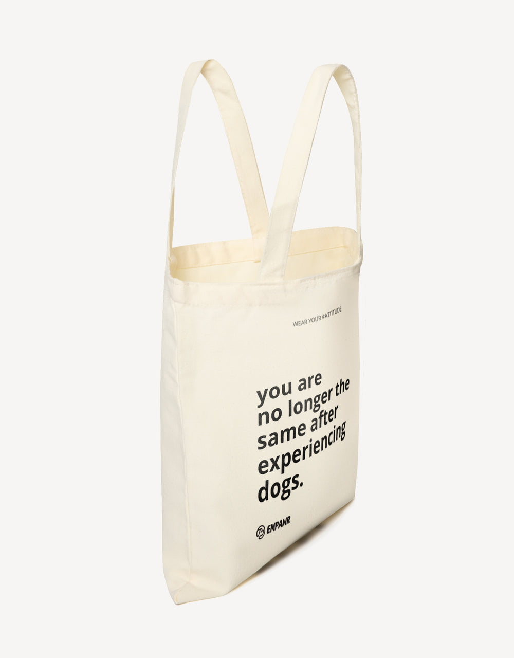 Off-white canvas tote bag with the quote "You are no longer the same after experiencing dogs" by Empawr.