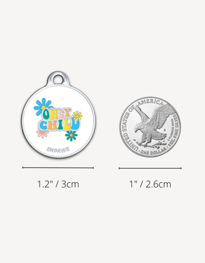 Colorful Empawr pet tag with "Only Child" message, size compared to a US silver dollar coin.