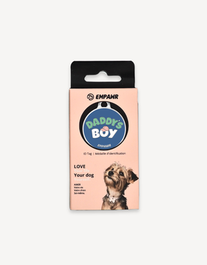 Empawr "Daddy's Boy" charm packaging, featuring a blue charm with white text and a pink baseball cap graphic on a card with the brand logo and the phrase "Love Your Dog." A small dog is pictured on the right side of the card.