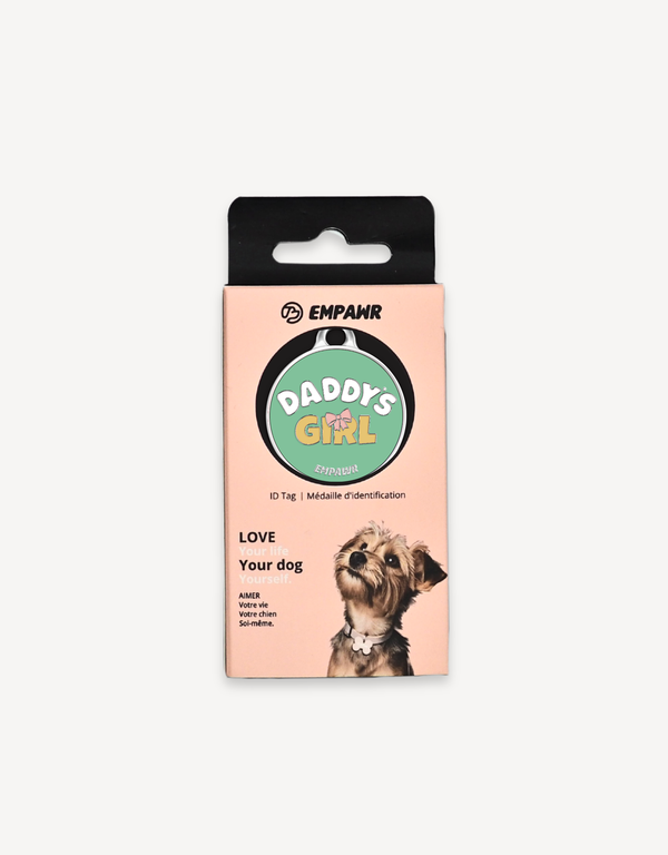 Empawr "Daddy's Girl" charm packaging, featuring a green charm with yellow text and a pink bow on a card with the brand logo and the phrase "Love Your Dog." A small dog is pictured on the right side of the card.