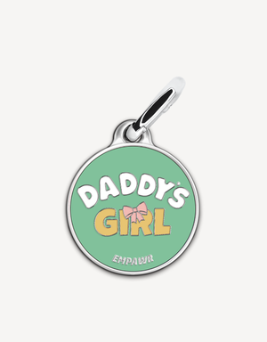 Empawr charm with the phrase "Daddy's Girl" in yellow letters on a green background, with a pink bow and silver trim. The brand name "EMPAWR" is at the bottom.