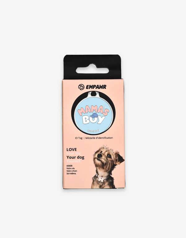 Empawr "Mama's Boy" charm packaging, featuring a light blue charm with pink letters and a blue baseball cap graphic on a card with the brand logo and the phrase "Love Your Dog." A small dog is pictured on the right side of the card.