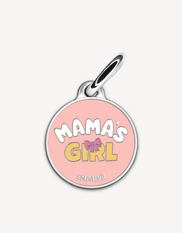 Empawr charm with the phrase "Mama's Girl" in yellow letters on a pink background, with a pink bow and silver trim. The brand name "EMPAWR" is at the bottom.