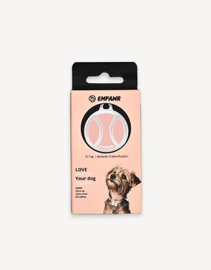 Empawr tennis ball charm packaging, featuring a pink tennis ball charm on a card with the brand logo and the phrase "Love Your Dog." A small dog is pictured on the right side of the card.